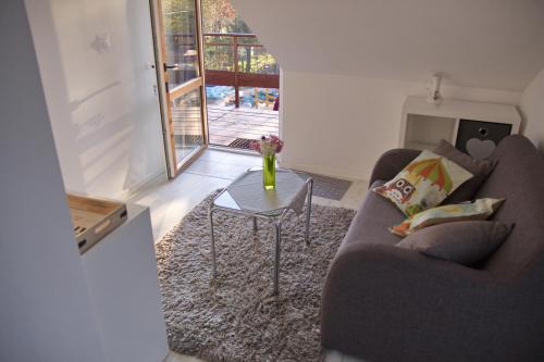 a living room with a couch and a table at Dworska Zagroda in Korytowo