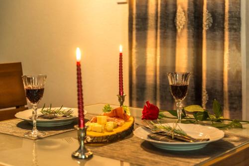a table with two candles and two glasses of wine at Apartments Stella del Mare in Risan