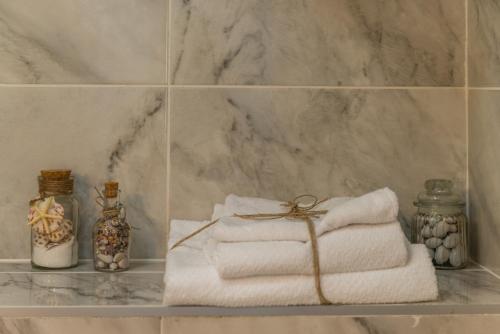 a pile of towels on a shelf in a bathroom at Apartments Stella del Mare in Risan