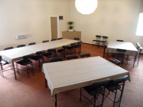 a large room with tables and chairs in it at Essex Arms in Huntly