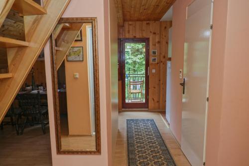 a hallway of a house with a mirror and a door at Dren - Banjska stena in Mitrovac