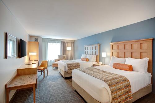 a large hotel room with two beds and a desk at The Glen House in Gorham