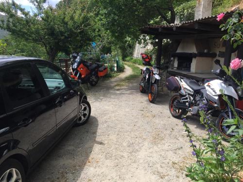 a group of motorcycles parked next to a car at Chalet Su Foxile in Aritzo