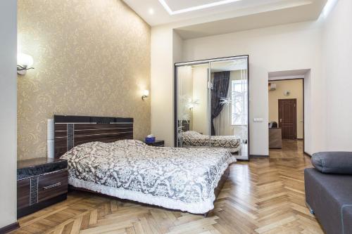 a bedroom with a bed and a large mirror at Odessa 3bedroom Deribas apartment in Odesa