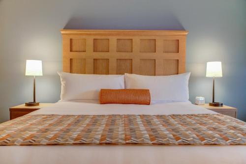 a bedroom with a large bed with two lamps at The Glen House in Gorham
