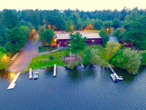 an aerial view of a building on a island in the water at St. Croix Inn in Solon Springs