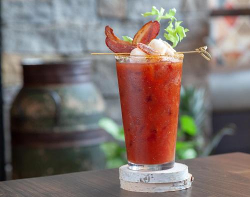 a drink with strawberries on top of a table at The Glen House in Gorham