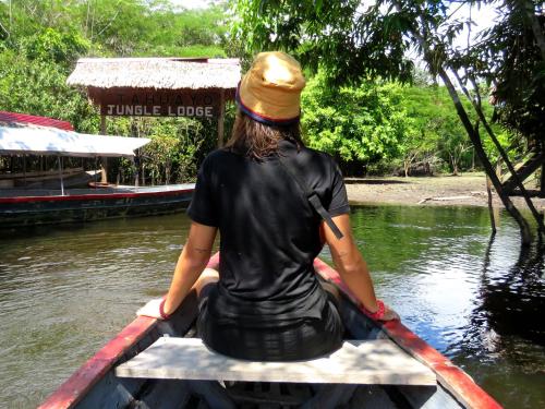 a woman sitting in a boat in the water at Intillama Jungle Lodge EIRL in Paucarpata