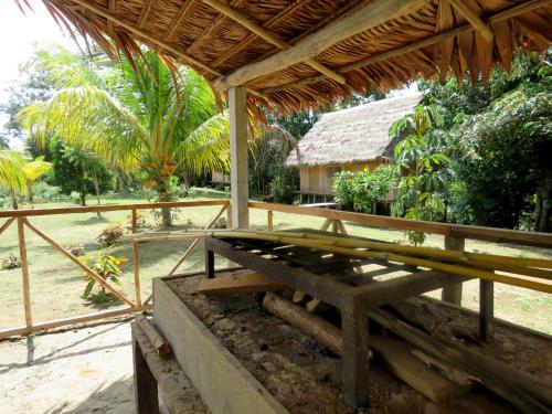 a wooden porch with a bench in front of a house at Intillama Jungle Lodge EIRL in Paucarpata