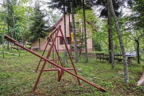 an old swing set in the yard of a house at Dren - Banjska stena in Mitrovac