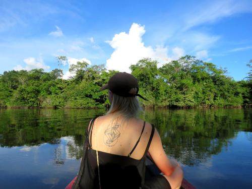 a woman in a kayak on a river at Intillama Jungle Lodge EIRL in Paucarpata