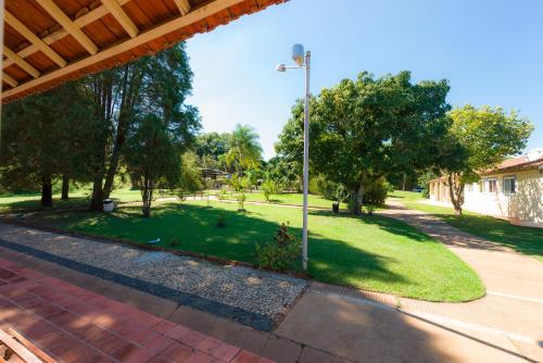 a view of a park with trees and a street light at Hotel Alto da Boa Vista in Analândia