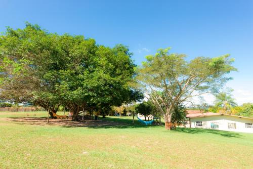 a park with trees and a swing at Hotel Alto da Boa Vista in Analândia
