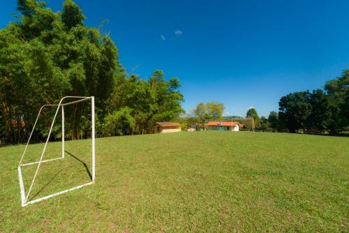 a soccer field with a goal in the grass at Hotel Alto da Boa Vista in Analândia