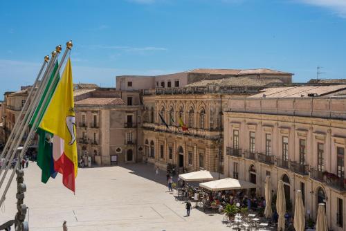 a group of flags in front of a building at D-Home Ortigia in Siracusa