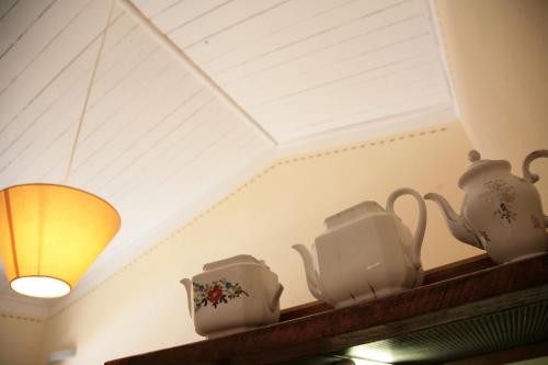 a shelf with tea pots and a light at Malvarina in Capodacqua