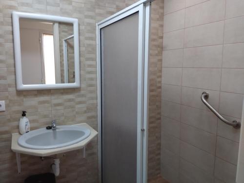 a bathroom with a sink and a mirror at Sweet Dreams near Beaches in Ponta Delgada