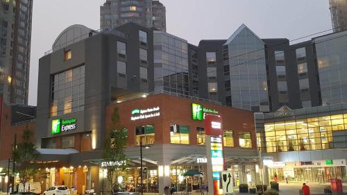 a large building with many windows in a city at Holiday Inn Express Vancouver-Metrotown (Burnaby) in Burnaby