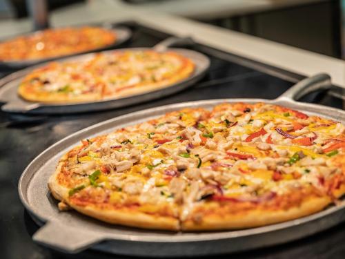 three pizzas sitting on top of a table at ON Hotels Oceanfront Adults Designed in Matalascañas