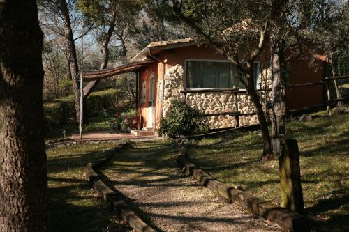 a cabin in the middle of a field with trees at Malvarina in Capodacqua