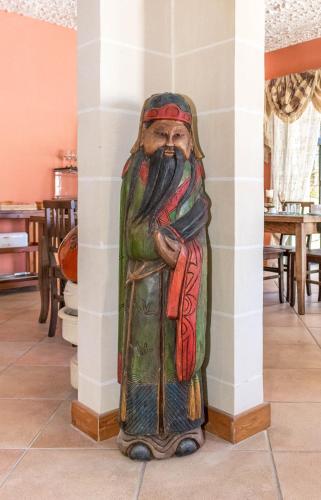 a statue of a man standing next to a column at Kikka B&B in Tarxien