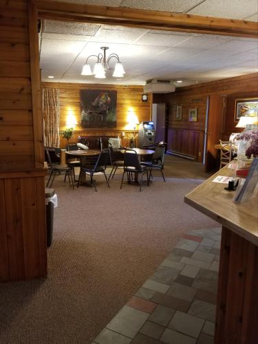 a dining room with a table and chairs in it at St. Croix Inn in Solon Springs