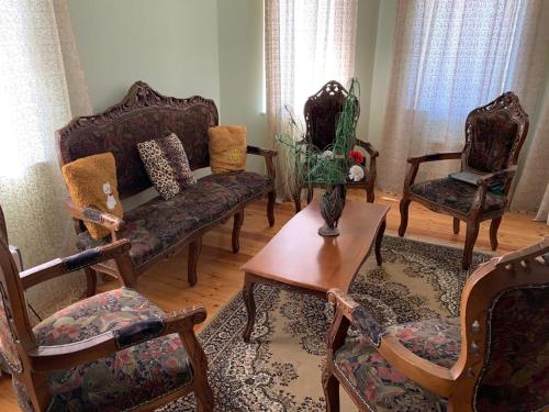 a living room with chairs and a couch and a table at Luxury Villa with pool and waterfall in Bina