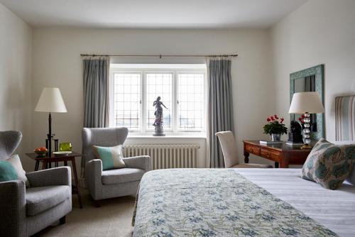 a hotel room with a bed and chairs and a window at Hotel Tresanton in Saint Mawes