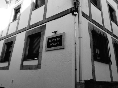 a building with a sign on the side of it at Travesia Rooms in Sarria