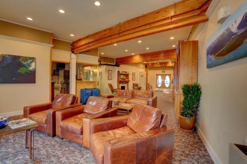 a living room filled with furniture and a large window at Land's End Resort in Homer
