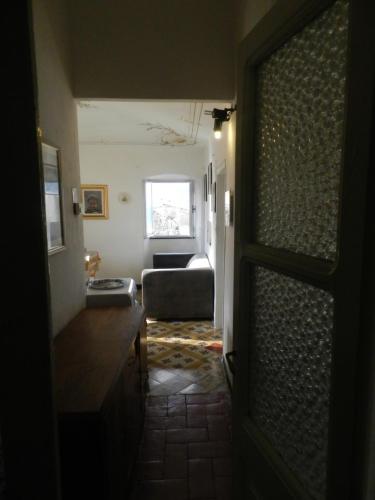 a living room with a couch and a window at Trilocale in dimora tipica in Montale