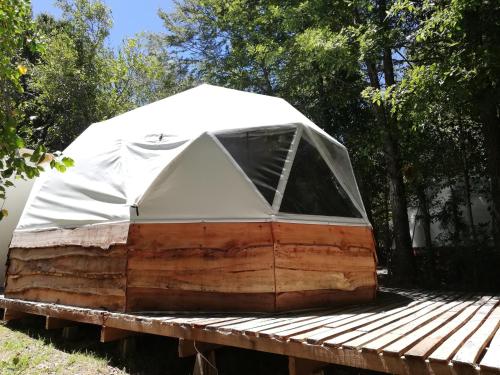 a white tent sitting on top of a wooden deck at Vortice Chile Eco-Lodge in Manzanar