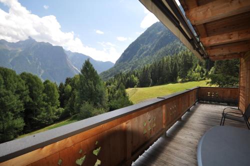 a balcony of a cabin with a view of mountains at Ferienhaus Oetztal in Sautens