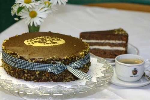 a chocolate cake on a plate next to a cup of coffee at Joglland Hotel Prettenhofer in Wenigzell