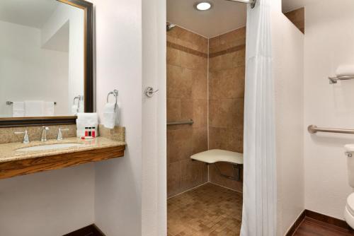 a bathroom with a sink and a shower at Ramada by Wyndham Spokane Airport in Spokane