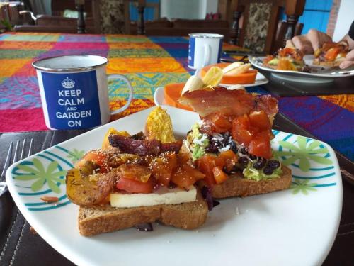 a plate of food with toast and vegetables on it at Buriti EcoH RNT56521, via Termales Santa Rosa de Cabal in Santa Rosa de Cabal