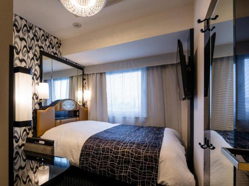 Postel nebo postele na pokoji v ubytování APA Hotel Komagome Ekimae