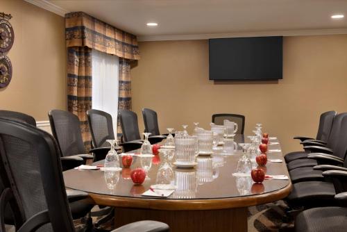a conference room with a table and chairs at Ramada by Wyndham Spokane Airport in Spokane