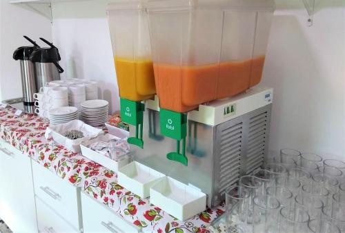 a drink dispenser on top of a table at Simas Praia Hotel in Aracaju