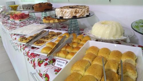 a buffet of pastries and cakes on a table at Simas Praia Hotel in Aracaju