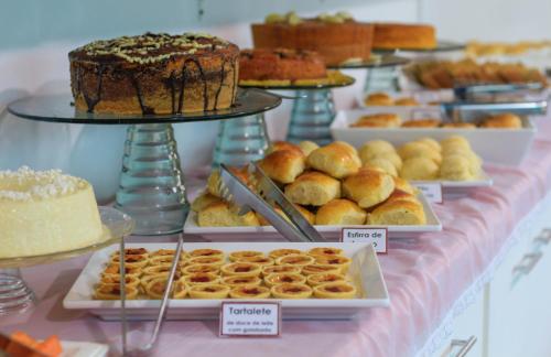 a table with different types of pastries and cakes at Simas Praia Hotel in Aracaju