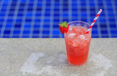 a strawberry in a drink sitting on a table at Simas Praia Hotel in Aracaju