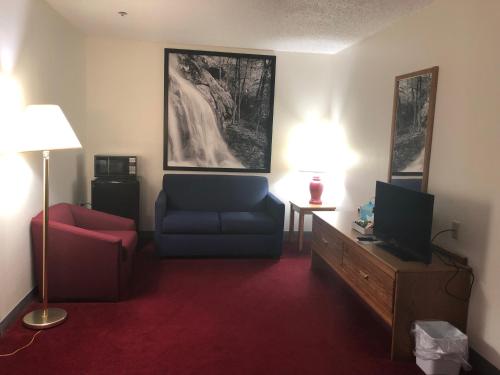 a living room with a couch and a tv at Super 8 by Wyndham Front Royal in Front Royal