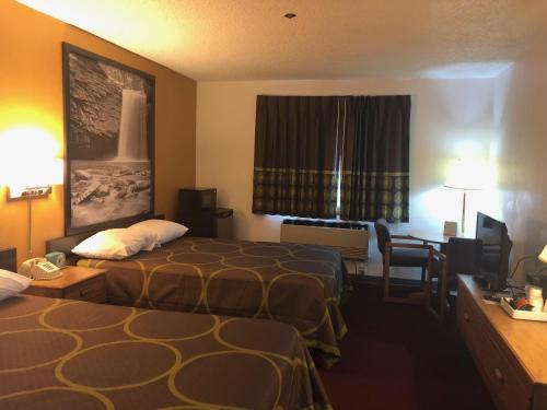 a hotel room with two beds and a desk at Super 8 by Wyndham Front Royal in Front Royal