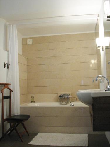 a bathroom with a bath tub and a sink at Pluweel in Nijmegen