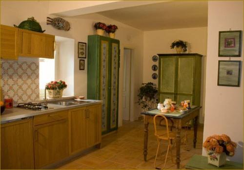 a kitchen with a sink and a table in it at Il Bruco appartamenti in b&b in San Donato Val di Comino