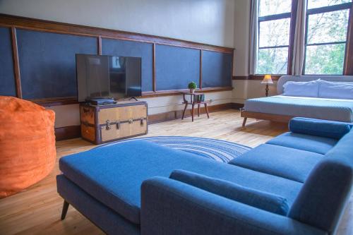 a living room with a couch and a tv at School 31 Lofts in Rochester