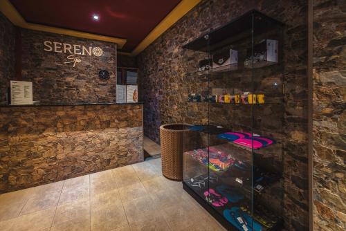 a bar in a room with a stone wall at Hotel Piatra Mare in Poiana Brasov