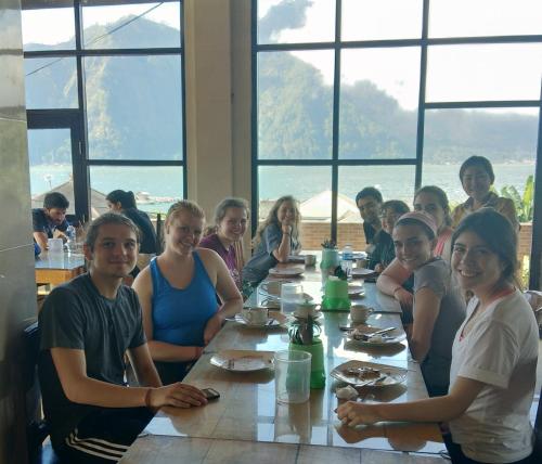 a group of people sitting at a long table at Volcano Living in Kintamani