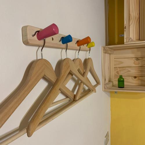 a shelf with four wooden hangers on a wall at Yamaharuka Historic House in Jinhu
